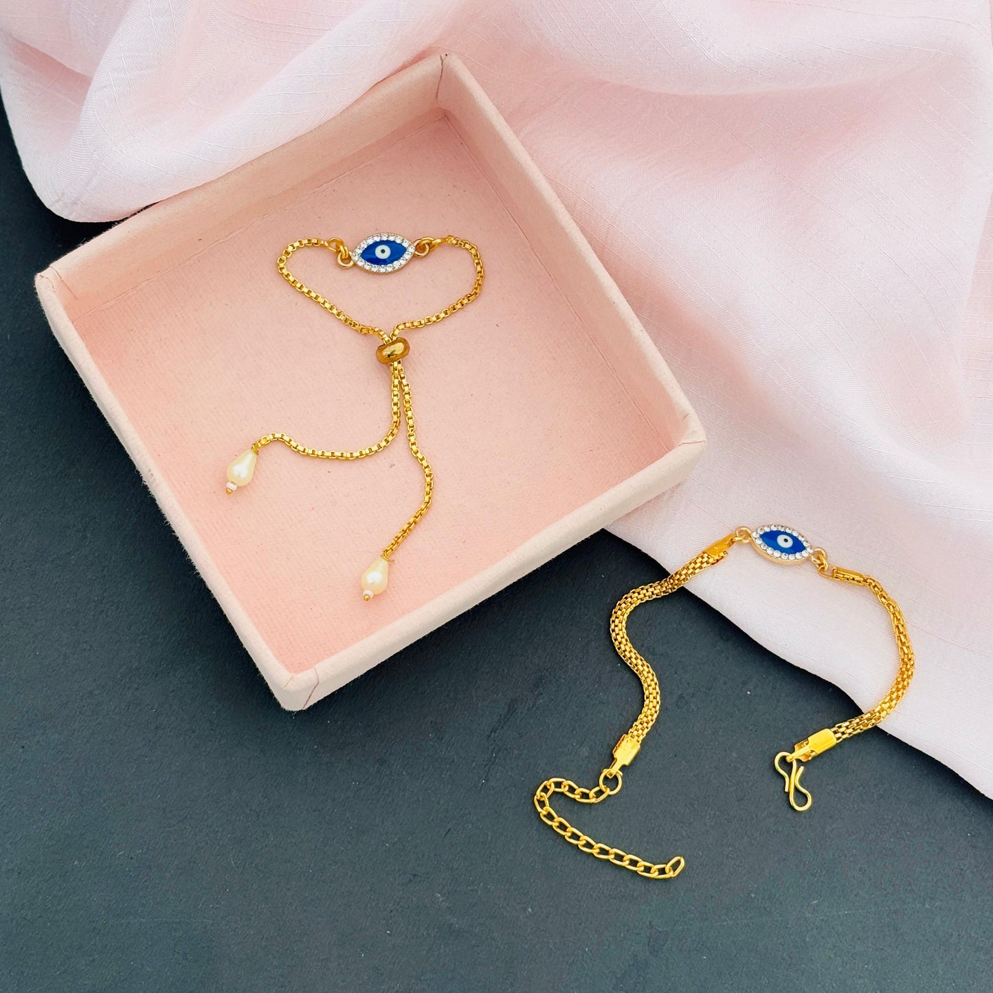 Evil Eye Duo Charm Rakhi for Bhaiya bhabhi with kumkum and rice– Gold-Toned Protection Set