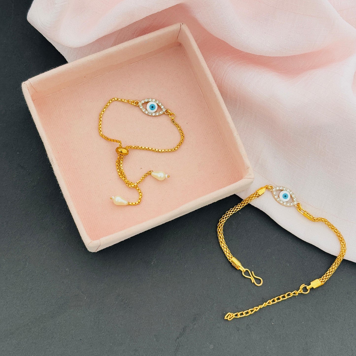 Evil Eye Duo Charm Rakhi for Bhaiya bhabhi with kumkum and rice– Gold-Toned Protection Set