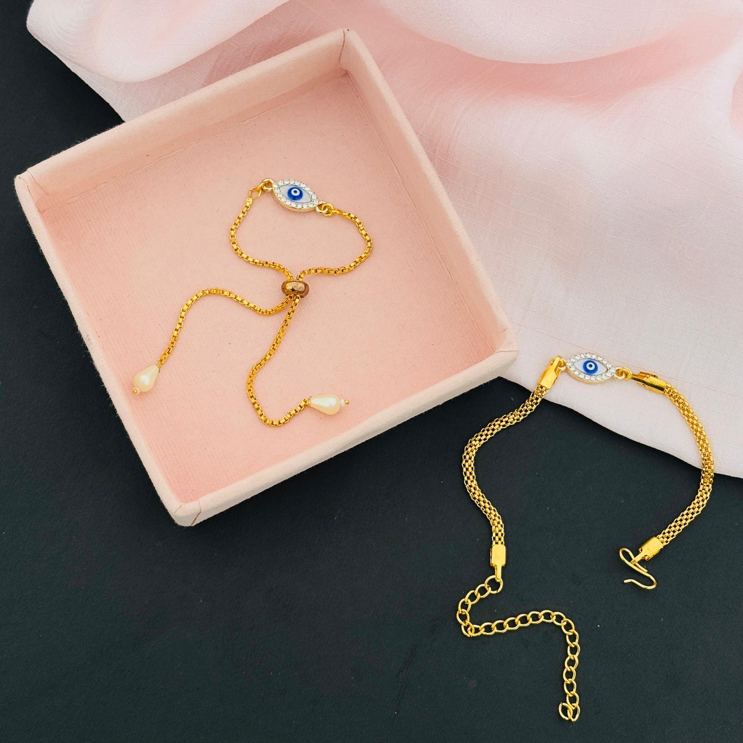 Evil Eye Duo Charm Rakhi for Bhaiya bhabhi with kumkum and rice– Gold-Toned Protection Set