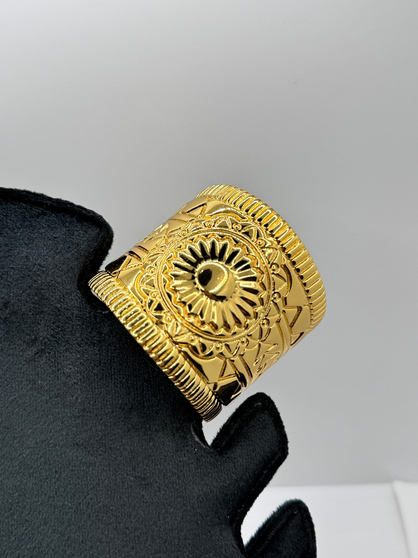 Wide Gold Cuff Bracelet with Embossed Medallion Pattern