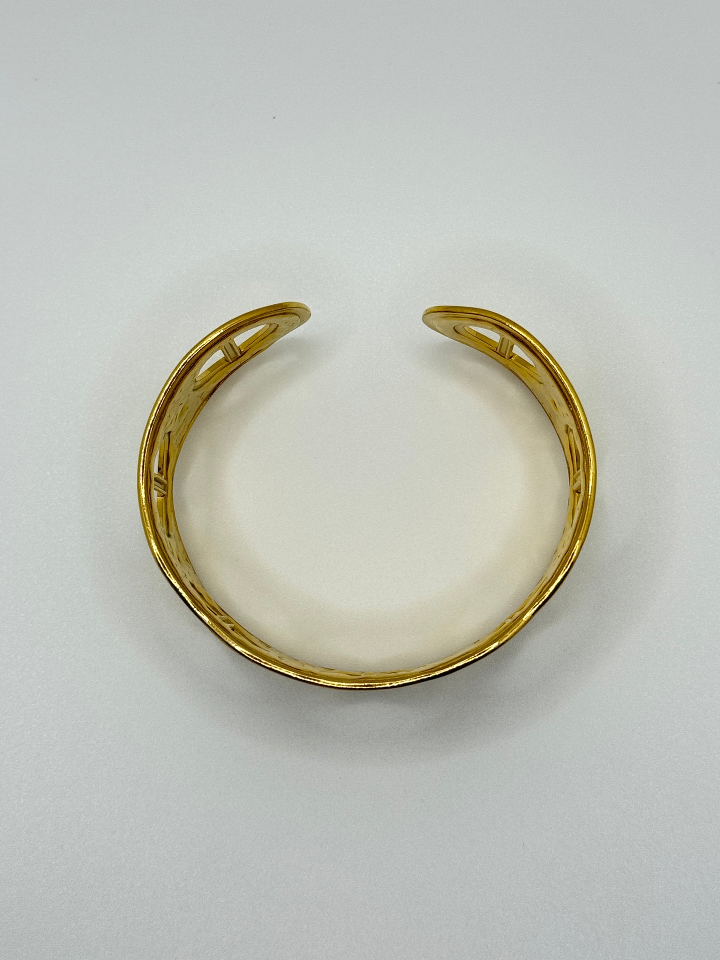 Ornate Gold Cuff Bracelet with Circular Cut-Outs