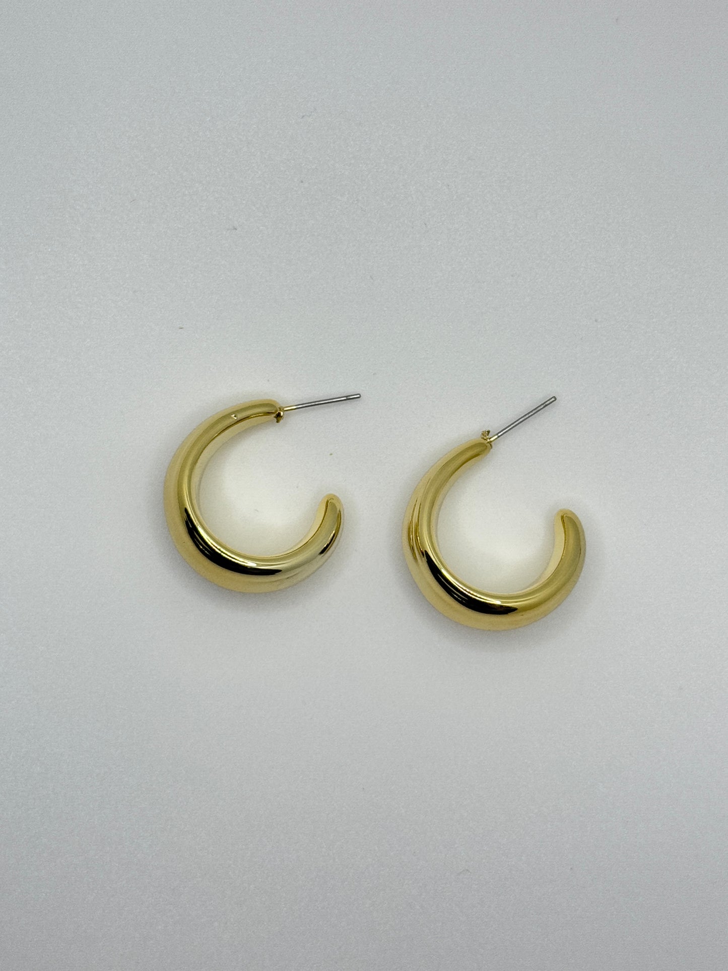 Polished Gold Teardrop Earring on Blue Display