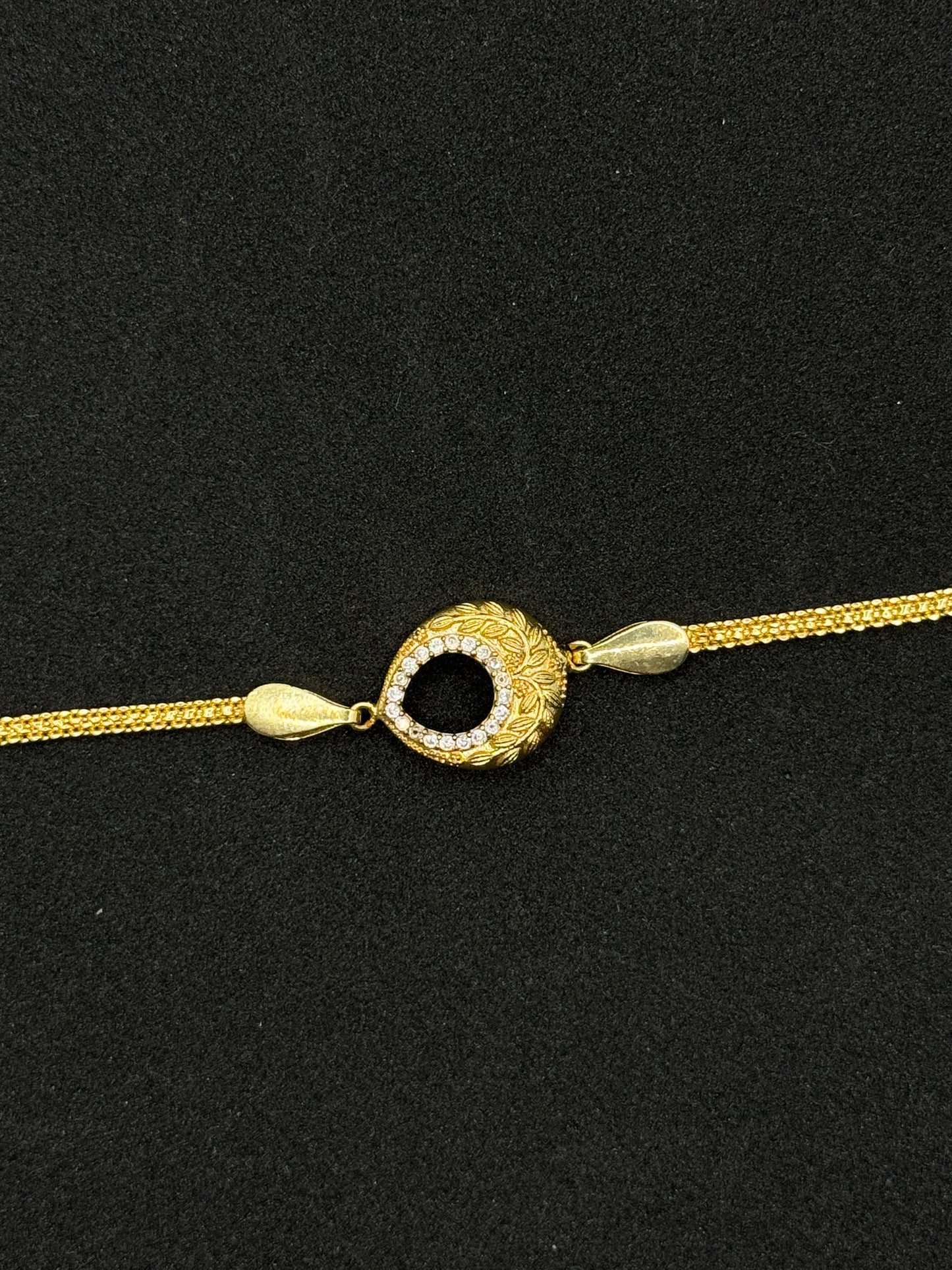 Ornate Gold Plated Rakhi with Stone Accents