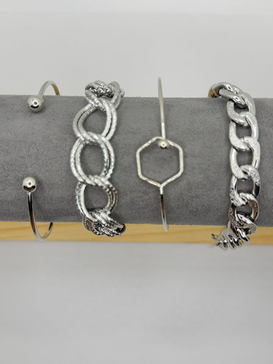 Four silver toned stacked bracelets